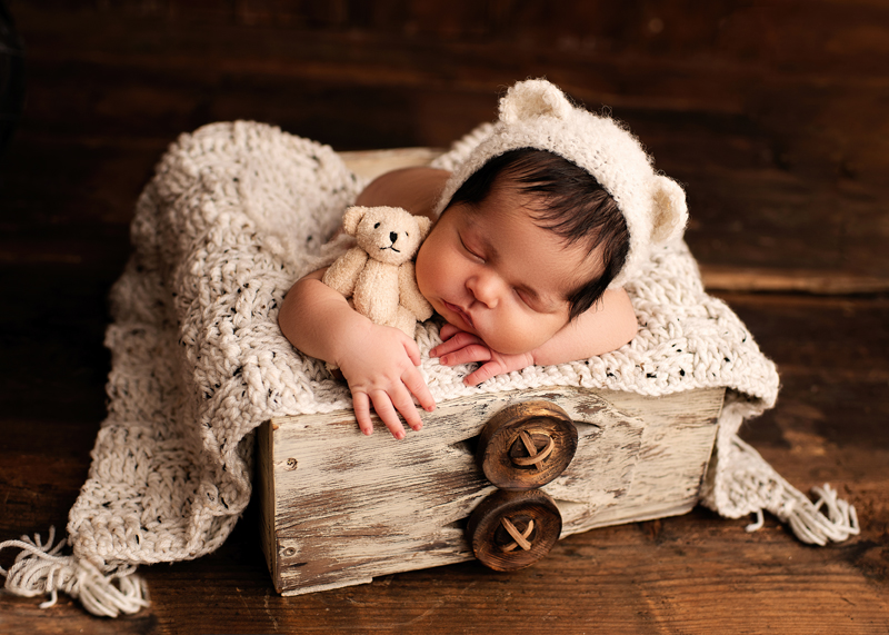Newborn Photography, baby sleeping in little big with bear ears on