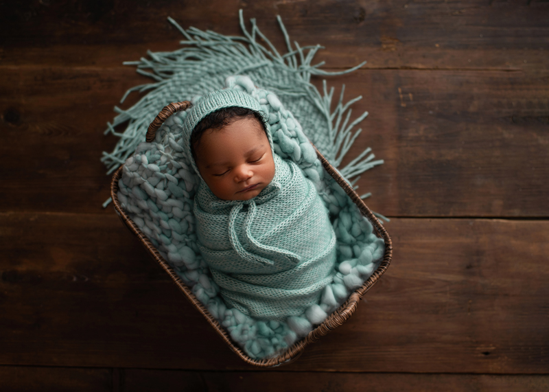 Newborn Photography, baby swaddled in blue blanket with matching cap